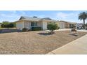 House with gravel landscaping and a two-car garage at 19619 N Signal Butte Cir, Sun City, AZ 85373