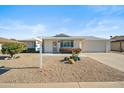 Single-story home with a landscaped front yard and attached garage at 19619 N Signal Butte Cir, Sun City, AZ 85373