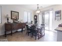 Dining area with wood table and chairs near a sliding glass door at 21081 E Via De Olivos --, Queen Creek, AZ 85142