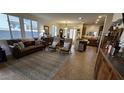 Cozy living room featuring tile floors, large windows, and comfortable seating arrangement at 21081 E Via De Olivos --, Queen Creek, AZ 85142