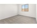 Bright bedroom features neutral carpet, window, and fresh, painted walls at 21888 E Saddle E Ct, Queen Creek, AZ 85142