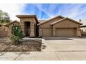 Tan two-story home with two car garage at 21964 N 59Th Ln, Glendale, AZ 85310