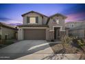 Two-story house with attached garage and landscaped yard at 23059 E Pummelos Rd, Queen Creek, AZ 85142