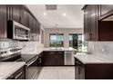 Modern kitchen featuring dark cabinetry and white countertops at 24421 W Morning Vista Ln, Wittmann, AZ 85361