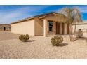 Newly built home with a tan exterior and gravel landscaping at 32014 N Redding St, Wittmann, AZ 85361