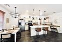 Open concept kitchen with island, stainless steel appliances, and pendant lights at 3948 E Morelos St, Gilbert, AZ 85295