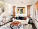 Living room with white couch, large artwork, and natural light at 3948 E Morelos St, Gilbert, AZ 85295