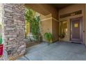 Inviting entryway with stone detailing and a covered porch at 4221 E Carriage Way, Gilbert, AZ 85297