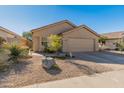 Single-story house with tan exterior, two-car garage, and desert landscaping at 4233 E Creosote Dr, Cave Creek, AZ 85331