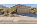 Single-story house with tan exterior, two-car garage, and desert landscaping at 4233 E Creosote Dr, Cave Creek, AZ 85331