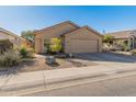 Single-story house with tan exterior, two-car garage, and desert landscaping at 4233 E Creosote Dr, Cave Creek, AZ 85331