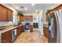 Kitchen with wood cabinets, granite countertops, and stainless steel appliances at 4333 W Shaw Butte Dr, Glendale, AZ 85304