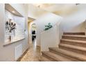 Two-story entry with a tile floor and carpeted staircase at 4333 W Shaw Butte Dr, Glendale, AZ 85304