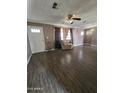 Bright living room featuring hardwood floors and a comfy chair at 4339 W Crittenden Ln, Phoenix, AZ 85031