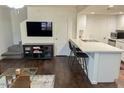 Modern kitchen with breakfast bar, white cabinets, and dark floors at 4760 E Portland St, Phoenix, AZ 85008