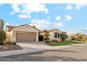 Tan house with brown garage door and green lawn at 4910 S Huachuca Pl, Chandler, AZ 85249