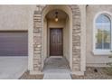 Front entry with stone details and a dark brown door at 4933 E Meadow Mist Ln, San Tan Valley, AZ 85140