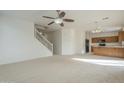 Open living room and kitchen with carpeted floors at 4933 E Meadow Mist Ln, San Tan Valley, AZ 85140