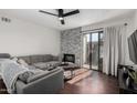 Bright living room with gray sectional sofa and fireplace at 533 W Guadalupe Rd # 1069, Mesa, AZ 85210