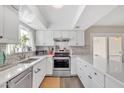 Modern kitchen with white cabinets, quartz countertops, and stainless steel appliances at 557 S Visalia St, Mesa, AZ 85202