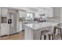 Modern kitchen featuring white shaker cabinets, quartz countertops, and stainless steel appliances at 557 S Visalia St, Mesa, AZ 85202