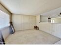 Living room with wood paneling and carpeted floors at 731 E Manor Dr, Casa Grande, AZ 85122