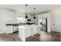 Modern kitchen featuring white cabinets, stainless steel appliances, and a large island at 7710 S 350Th Ave, Tonopah, AZ 85354