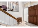 Bright entryway with wooden staircase and tiled floor at 7800 E Lincoln Dr # 2053, Scottsdale, AZ 85250