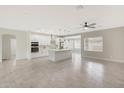 Modern kitchen with white cabinets and a large island at 7818 W Encinas Ln, Phoenix, AZ 85043