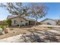 Landscaped yard with a single story house and driveway at 7915 W Wethersfield Rd, Peoria, AZ 85381