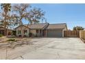 Charming ranch house with a gray garage door and spacious driveway at 7915 W Wethersfield Rd, Peoria, AZ 85381