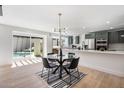 Bright dining area and kitchen with an outdoor view of the pool and black modern dining set at 8013 N 73Rd St, Scottsdale, AZ 85258