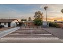 Charming home featuring desert landscaping and a cozy front patio with wood slat privacy screen at 811 W Whitton Ave, Phoenix, AZ 85013