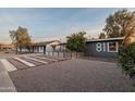 Charming home featuring desert landscaping and a cozy front patio with wood slat privacy screen at 811 W Whitton Ave, Phoenix, AZ 85013