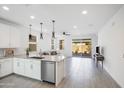 Modern kitchen island with white cabinets and stainless steel appliances at 8908 W Bethany Heights Dr, Glendale, AZ 85305