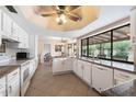 Well-equipped kitchen boasting granite countertops and white cabinetry at 9041 E Ludlow Dr, Scottsdale, AZ 85260