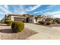 Attractive single-story home boasting a well-manicured desert landscape and a two-car garage at 9144 W Sands Dr, Peoria, AZ 85383