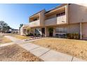 Tan townhome with walkway and landscaping, sunny exterior at 944 S Valencia -- # 3, Mesa, AZ 85202