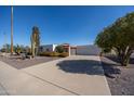 Single-level home with a carport and desert landscaping at 9533 W Cedar Hill N Cir, Sun City, AZ 85351