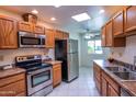 Clean and bright kitchen with stainless steel appliances and wood cabinets at 10114 W Campana Dr, Sun City, AZ 85351