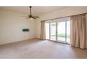 Living room with sliding glass doors leading to a patio at 10114 W Campana Dr, Sun City, AZ 85351