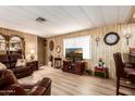 Living room with leather furniture and a large-screen TV at 11411 N 91St Ave # 131, Peoria, AZ 85345