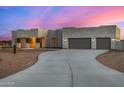 Contemporary home exterior with long driveway and desert landscaping at 12093 W Blackhawk Rd, Casa Grande, AZ 85194