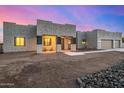 Modern home with a three-car garage and covered entryway at 12093 W Blackhawk Rd, Casa Grande, AZ 85194