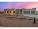 Modern stucco home with a three-car garage and gated entry at 12093 W Blackhawk Rd, Casa Grande, AZ 85194