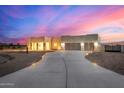 Beautiful desert home with a three-car garage and lighted driveway at 12093 W Blackhawk Rd, Casa Grande, AZ 85194