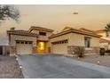 Single-story home with stone accents and a two-car garage at 13434 W Jacobson Dr, Litchfield Park, AZ 85340