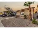 Landscaped front yard with gravel and a palm tree at 13434 W Jacobson Dr, Litchfield Park, AZ 85340