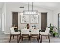 Modern dining room with glass-top table and wood chairs at 15045 W Mulberry Dr, Goodyear, AZ 85395