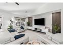 Spacious living room with white sofas and a large flat-screen TV at 15045 W Mulberry Dr, Goodyear, AZ 85395